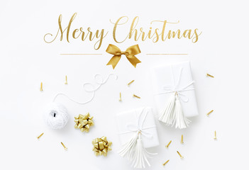 Christmas gift wrapping gold and white flat lay with gift boxes and greeting text