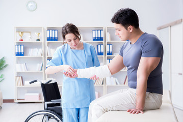 Fototapeta premium Doctor and patient during check-up for injury in hospital