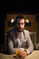 Man in a pub, drinking craft beer, watching in camera