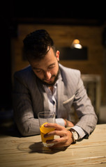 Sad man in a pub, watching his beer
