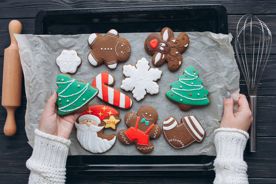 A preparation and making cookies for Christmas party on a wooden background.