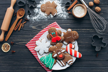 A preparation and making cookies for Christmas party on a wooden background.