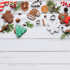 Homemade delicious Christmas gingerbread cookies on the white wooden background.