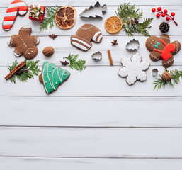Homemade delicious Christmas gingerbread cookies on the white wooden background.