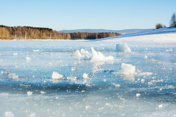 Frozen lake surface with ice cracks