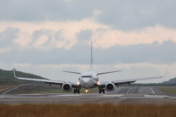 passenger plane rides after landing,  front view/  included landing lights at the...