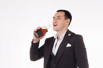 Confident well-dressed man drinking whiskey