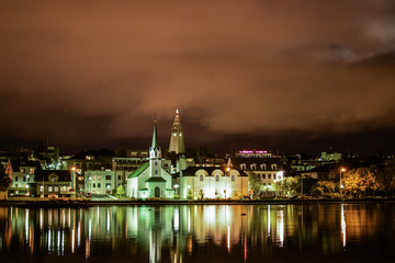 Naklejka na ściany i meble Reykjavik city seen from the pond at night