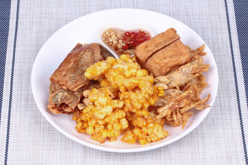 Deep fried dessert of sweet corn,tofu ,taro and  spring roll served with spicy sweet sauce.