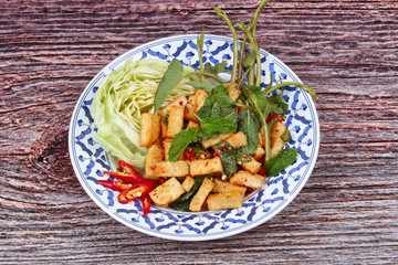 Spicy sour mixed herb salad with fried tofu.
