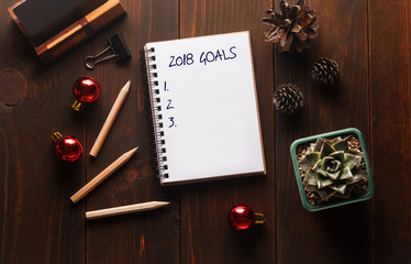 Top view 2018 goals list with notebook. New year resolution concepts. Planning of the new year