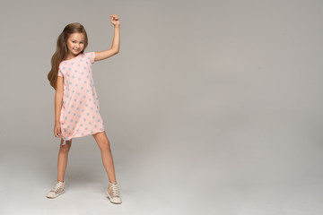 Happy young girl in pink dress