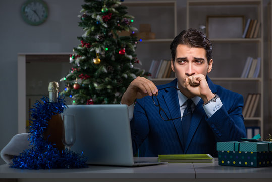 Businessman working late on christmas day in office