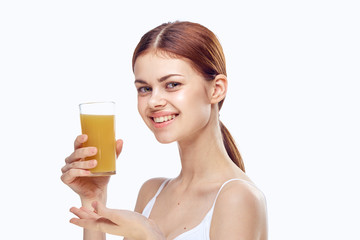 Young beautiful woman on white isolated background holds a glass of juice, diet, fitness, slimming