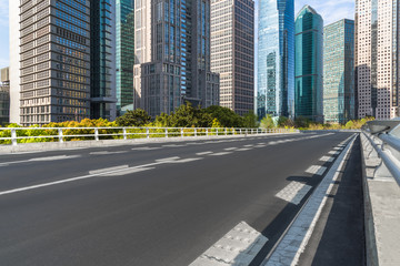 Fototapeta premium empty asphalt road on modern bridge with city skyline background.
