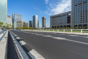 road through the bridge with city skyline background.