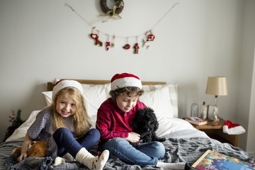 A Caucasian siblings enjoying Christmas holiday