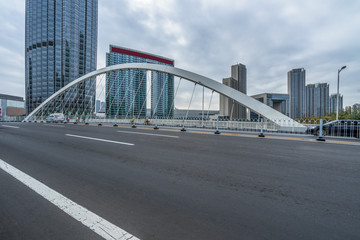 clean road and modern bridge with tianjin city skyline scenery,China.