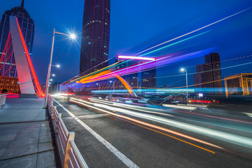 Fototapeta na wymiar light trails through the bridge in the downtown district, china.