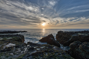 Fototapeta na wymiar Rocky Ledge Sunset Pacific Ocean
