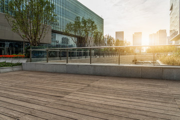 Empty wooden footpath front modern building.