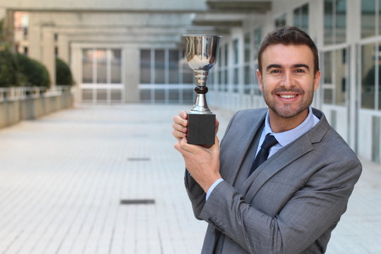 Proud Businessman Holding His Trophy 