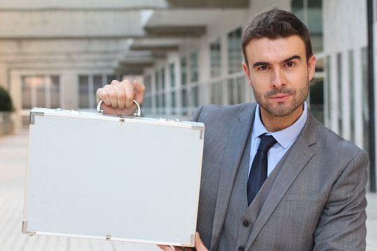 Suspicious businessman holding a briefcase 