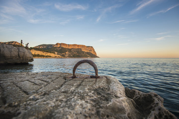 Fototapeta premium View of coastline in France with ancient ring for mooring boats in foreground