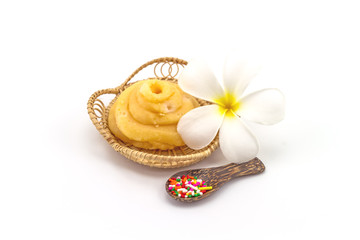 Palmyra Palm (Borassus flabellifer Linn.) Palmae Jaggery or sugar from palm or coconut , frangipani flowers sprinkle sugar and wooden spoon in Rattan weave mat on white background