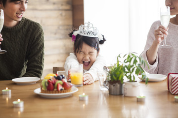 Dad and mommy are celebrating her daughter 's birthday.