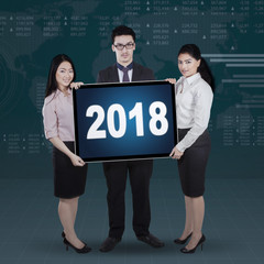 Business people holding numbers 2018