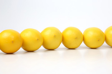 whole lemons together on white background.