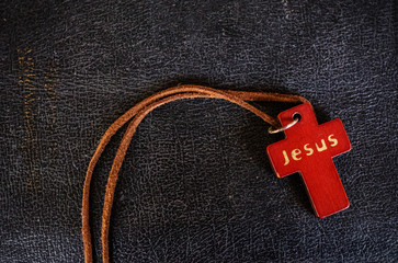 Closeup of wooden Christian cross on bible