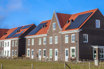 Fototapeta na wymiar Modern row houses with solar panels on sunny day