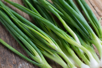Pile of fresh spring onion on wood table