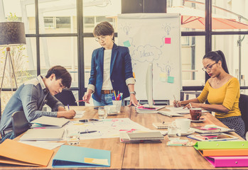 Group Of Asian and Multiethnic Business people with casual suit working and brainstorming together with technology computer in the modern Office, people business group concept