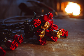 Naklejka premium A metal forged rose lies on the pier in the smithy