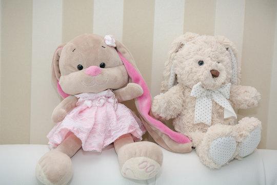 Teddy bears sit on a soft sofa. Two teddy bears.