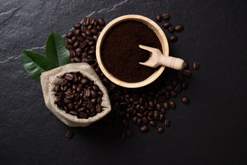 Top view mockup coffee beans and powder coffee in bowl on the black stone.