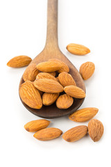 Heap of shelled almond kernels in wooden spoon