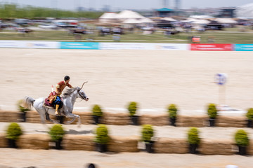 people in costumes of ancient Ottoman Empire archer soldiers shooting at archery competition