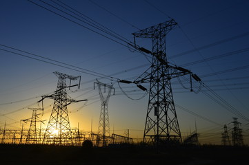 The silhouette of the evening electricity transmission pylon