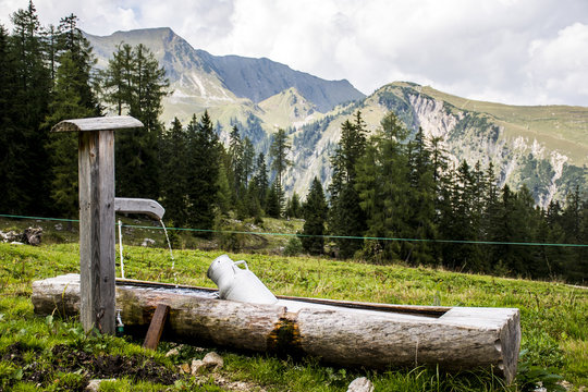 Water feeding trough Austria with mountains