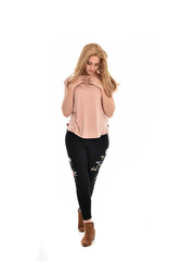 full length portrait of a girl wearing pink shirt and black floral pants. standing pose, isolated on white background.