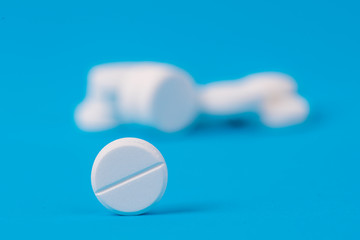 white medical drug on blue background