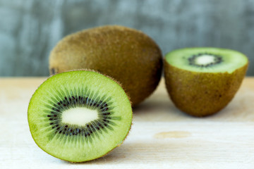 Fresh Kiwi fruit on wooden table in kitchen room.