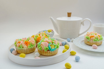 Top view decorated cupcakes with Easter eggs on white Background.