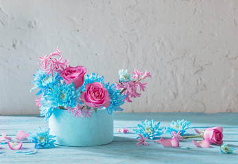 blue and pink flowers in box on wooden table