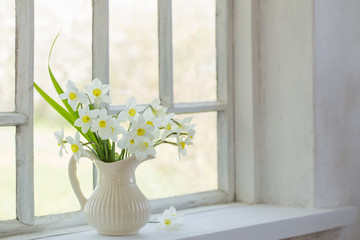 daffodils in jug on windowsill