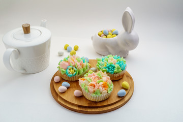 Top view decorated cupcakes with Easter eggs on white Background.